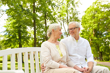 Image showing happy senior couple hugging in city park