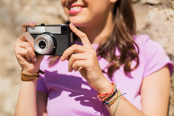 Image showing close up of woman with vintage camera outdoors