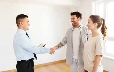 Image showing man and realtor shaking hands at new home