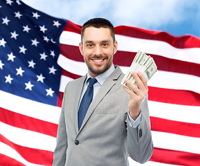 Image showing smiling businessman with american dollar money