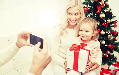 Image showing family taking picture with smartphone at christmas