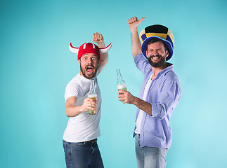 Image showing Two Excited Male Friends Celebrate Watching Sports