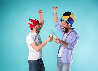 Image showing Two Excited Male Friends Celebrate Watching Sports