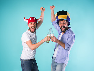 Image showing Two Excited Male Friends Celebrate Watching Sports