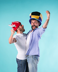 Image showing Two Excited Male Friends Celebrate Watching Sports