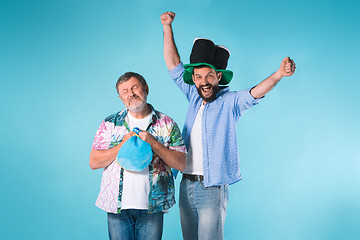 Image showing The two football fans over blue