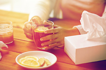 Image showing close up of ill woman drinking tea with lemon