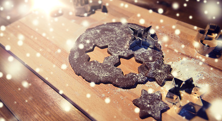 Image showing close up of ginger dough, molds and flour on board