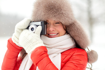 Image showing happy woman with film camera outdoors in winter