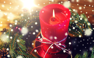 Image showing fir branch wreath with candle on wooden table