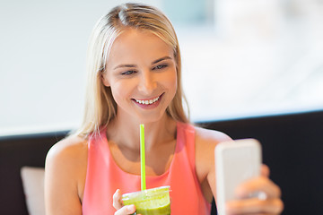 Image showing woman with smartphone taking selfie at restaurant