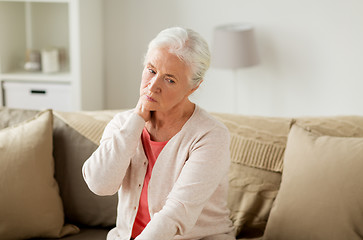 Image showing senior woman suffering from neck pain at home