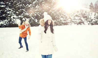 Image showing happy couple playing snowballs in winter