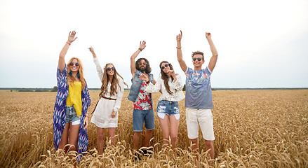 Image showing happy young hippie friends dancing on cereal field