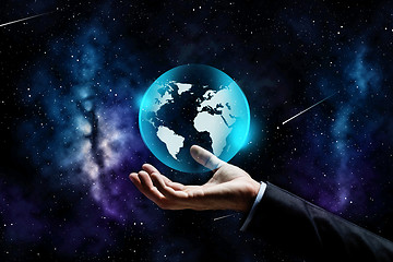 Image showing close up of businessman hand with earth projection