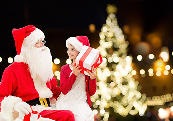 Image showing santa claus and happy girl with christmas gift