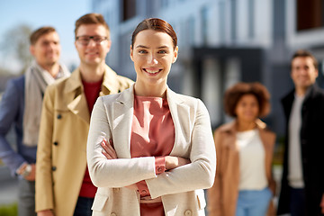 Image showing woman in front of international team outdoors