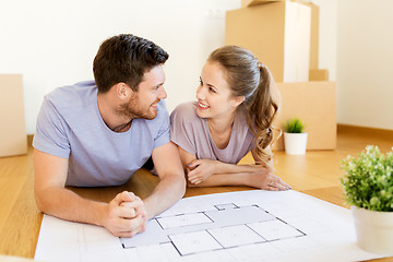 Image showing couple with boxes and blueprint moving to new home