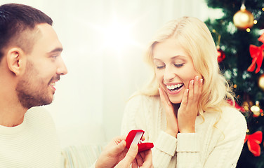 Image showing man giving woman engagement ring for christmas