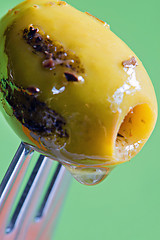 Image showing Closeup grilled olive on the fork