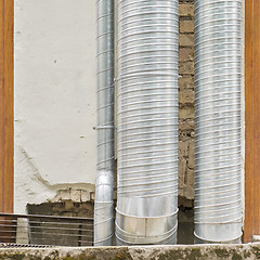 Image showing air condition metal pipes near the wall