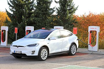 Image showing White Tesla Model S SUV Charging Battery