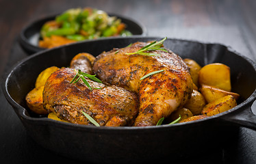 Image showing Baked chicken legs with potatos