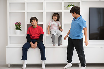 Image showing young boys posing on a shelf