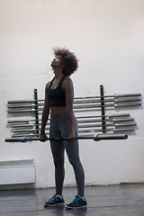 Image showing black woman lifting empty bar