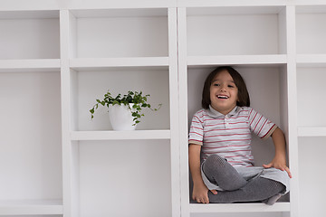 Image showing young boy posing on a shelf