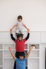 Image showing young boys posing line up piggyback