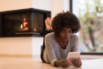 Image showing black women using tablet computer on the floor