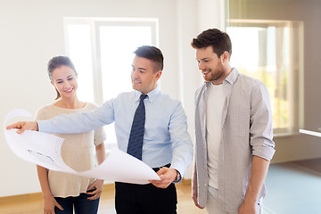 Image showing realtor showing blueprint of new home to couple