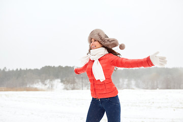 Image showing happy woman in winter fur hat having fun outdoors