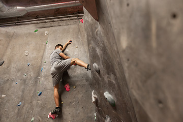 Image showing young man exercising at indoor climbing gym wall