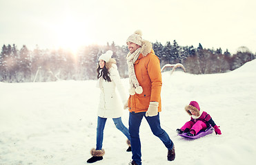 Image showing happy family with sled walking in winter outdoors