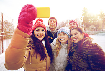 Image showing happy friends taking selfie with smartphone