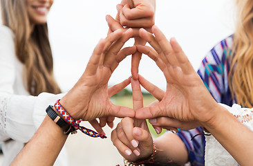 Image showing hands of hippie friends showing peace sign