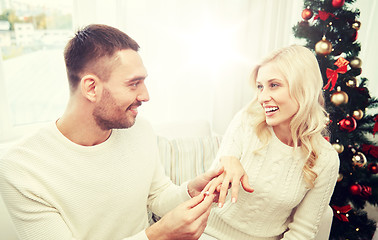Image showing man giving engagement ring to woman for christmas