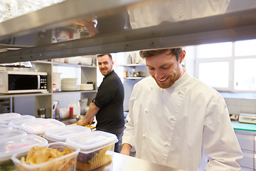 Image showing chef and cook cooking food at restaurant kitchen