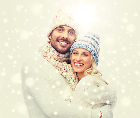 Image showing smiling couple in winter clothes hugging