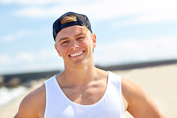 Image showing smiling young man on summer beach