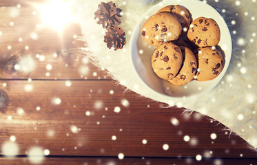 Image showing close up of cookies in bowl and cones on fur rug