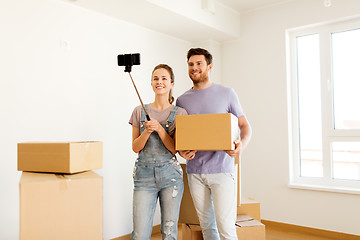 Image showing happy couple with boxes moving to new home