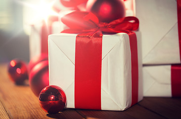 Image showing close up of gift boxes and red christmas balls