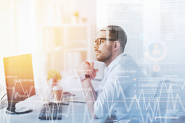 Image showing businessman in glasses sitting at office computer