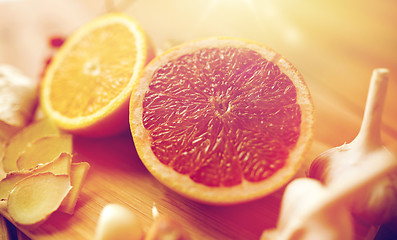 Image showing citrus fruits, ginger and garlic on wood