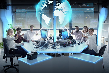 Image showing happy business team with earth hologram at office