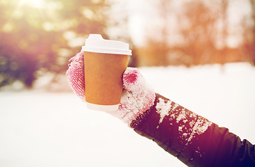 Image showing close up of hand with coffee outdoors in winter