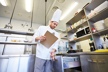 Image showing chef with clipboard doing inventory at kitchen